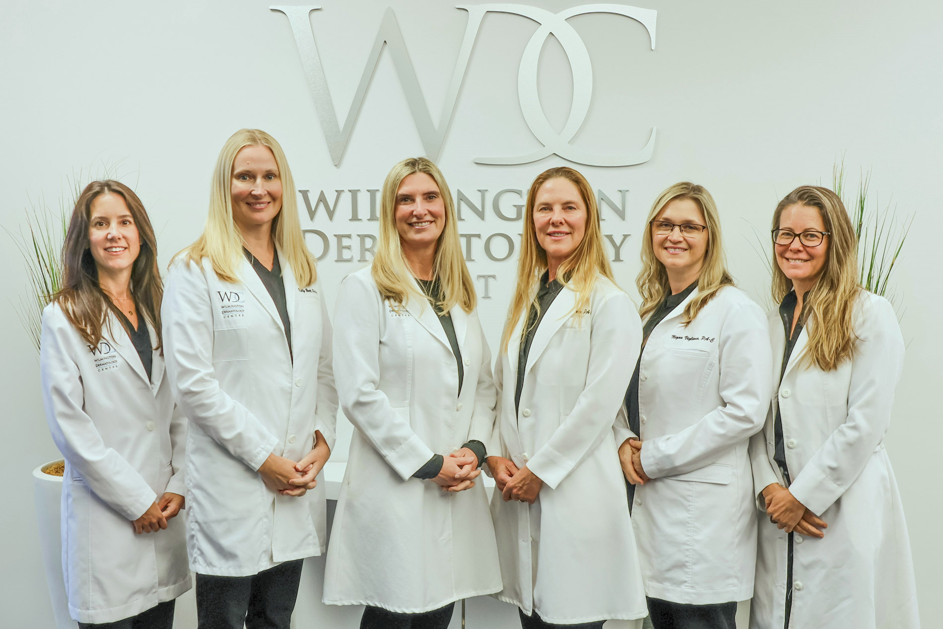 Meet the Expert Dermatology Team at Wilmington Dermatology Center in North Carolina The experienced medical providers at Wilmington Dermatology Center standing together in white coats, dedicated to advanced skin care and aesthetic dermatology in Wilmington NC